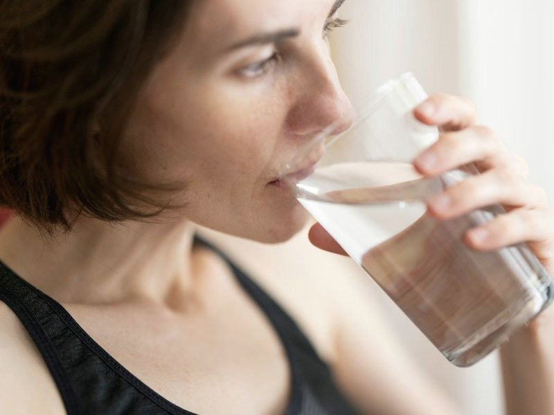 A woman drinking a glass of water