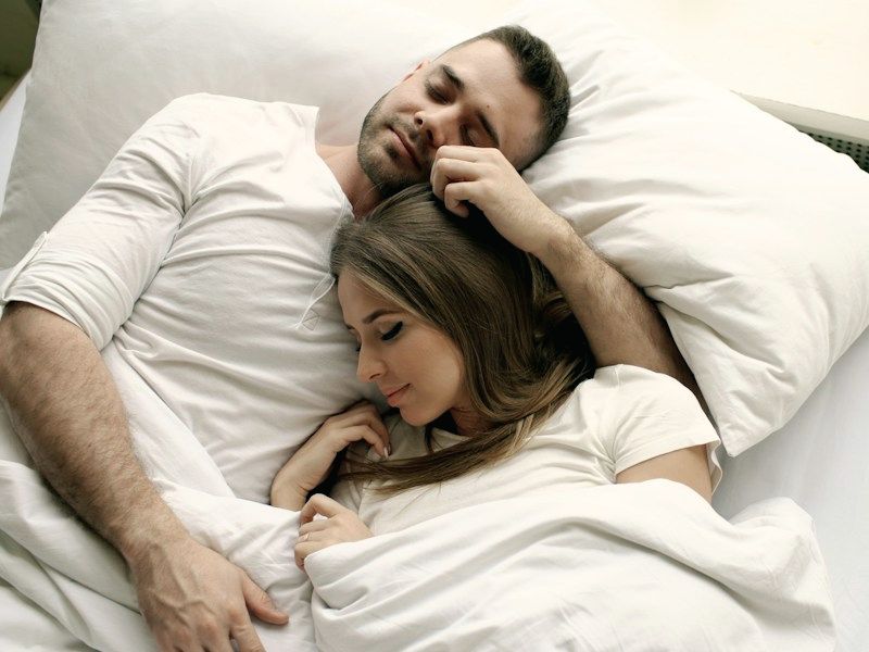 A couple asleep in bed